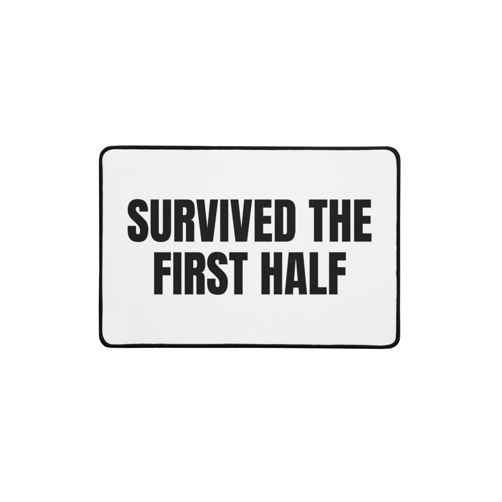 SURVIVED THE FIRST HALF desk mat